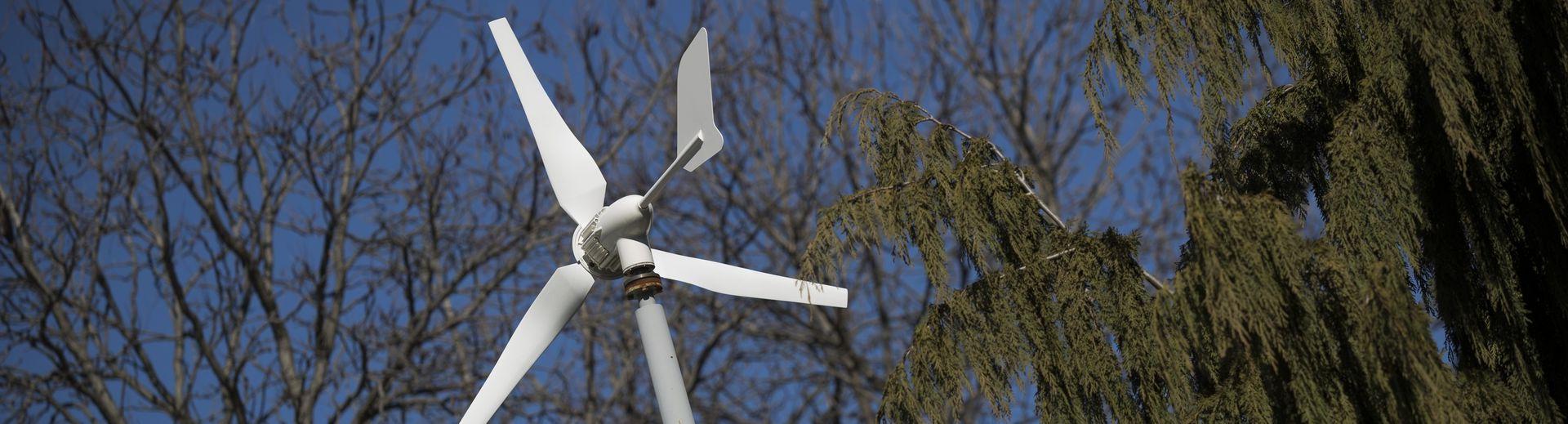 A wind turbine and a sunny, blue sky.